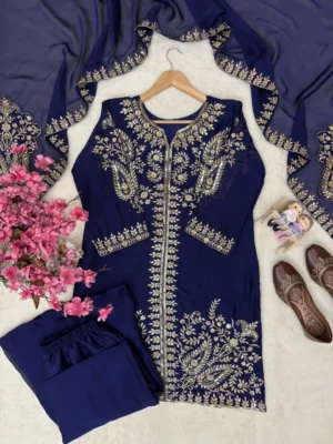 Model posing in a navy blue Pakistani salwar kameez suit featuring intricate gold zari and tilla floral embroidery on the kurta, paired with matching wide-leg palazzo pants and a sheer chiffon dupatta - Navy Blue Embroidered Pakistani Salwar Kameez Suit with Palazzo