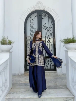 Model posing in a navy blue Pakistani salwar kameez suit featuring intricate gold zari and tilla floral embroidery on the kurta, paired with matching wide-leg palazzo pants and a sheer chiffon dupatta - Navy Blue Embroidered Pakistani Salwar Kameez Suit with Palazzo