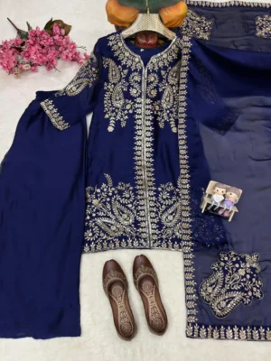 Model posing in a navy blue Pakistani salwar kameez suit featuring intricate gold zari and tilla floral embroidery on the kurta, paired with matching wide-leg palazzo pants and a sheer chiffon dupatta - Navy Blue Embroidered Pakistani Salwar Kameez Suit with Palazzo