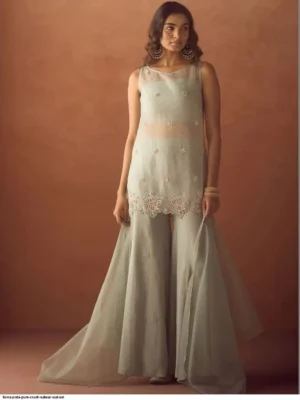 Model wearing a FIORRA sea green crush organza sleeveless straight kurta featuring delicate hand work and floral lace detailing at the hem, paired with matching wide-leg palazzo pants and an organza dupatta - Women Sea Green Crush Organza Hand Work Straight Kurta Set with Dupatta