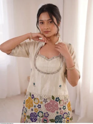 vory cream tissue shimmer silk ethnic co-ord set featuring a short kurta with an embroidered sweetheart bustier panel, real mirror work along the neckline, and a heavy multicolored floral sequin border, paired with loose matching palazzo pants