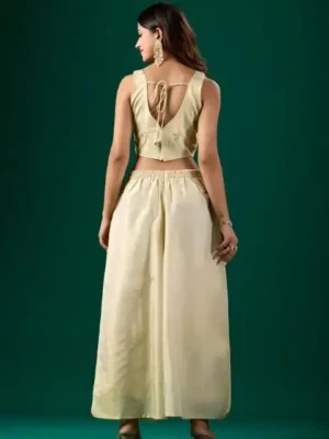 Off-white nylon tissue embroidered party wear co-ord set for women featuring a stitched crop top, matching wide-leg palazzo pants, and an intricate gold embroidered jacket.- off white stitched naylon tissue embroidered party wear