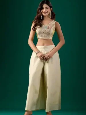 Off-white nylon tissue embroidered party wear co-ord set for women featuring a stitched crop top, matching wide-leg palazzo pants, and an intricate gold embroidered jacket.- off white stitched naylon tissue embroidered party wear